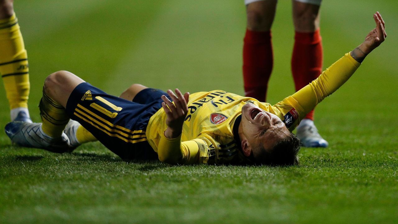 Arsenal's Uruguayan midfielder Lucas Torreira reacts after picking up an injury during the English FA Cup fifth round football match between Portsmouth and Arsenal at Fratton Park stadium in Portsmouth, southern England, on March 2, 2020.