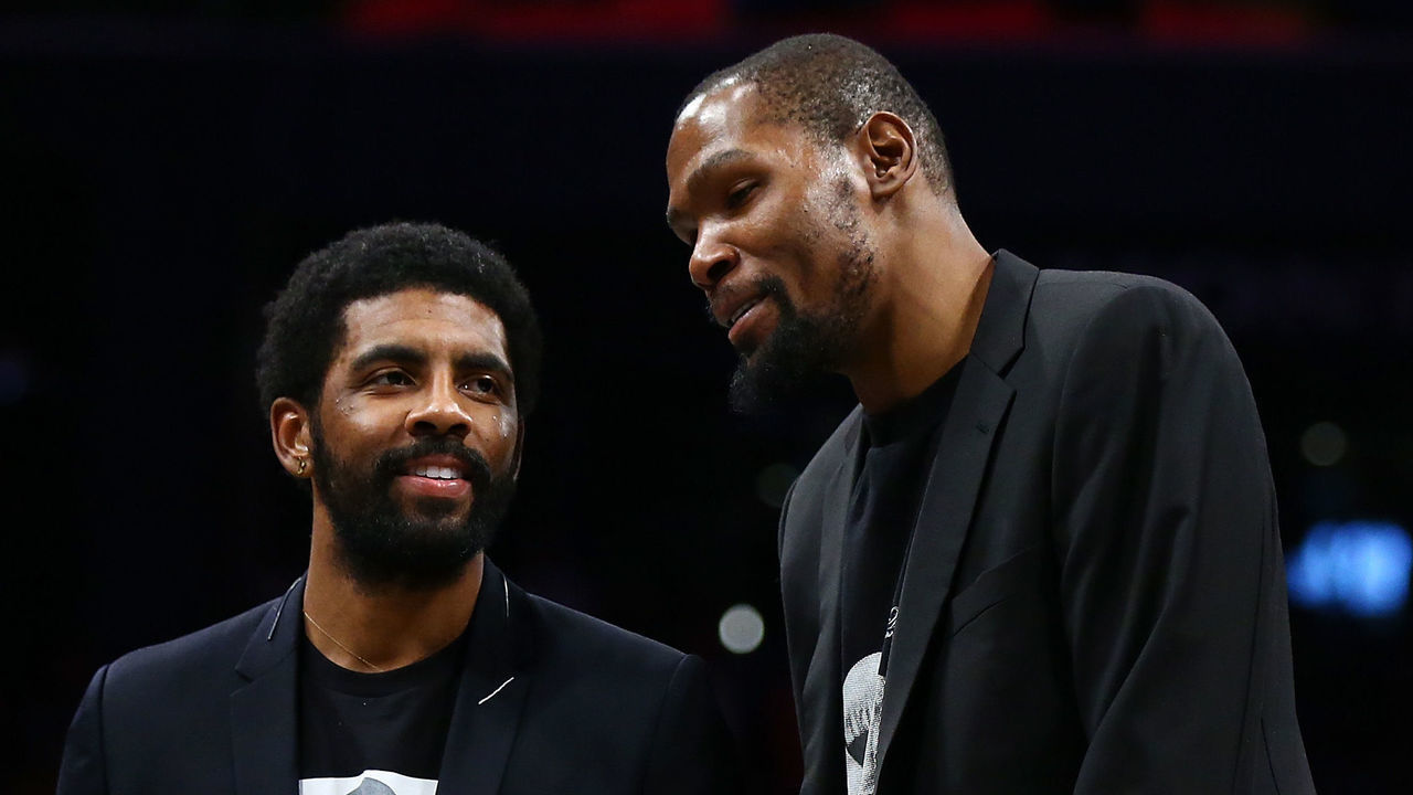 NEW YORK, NEW YORK - DECEMBER 08: Kevin Durant #7 and Kyrie Irving #11 of the Brooklyn Nets share a laugh during the game against the Denver Nuggets at Barclays Center on December 08, 2019 in New York City. Brooklyn Nets defeated the Denver Nuggets 105-102.