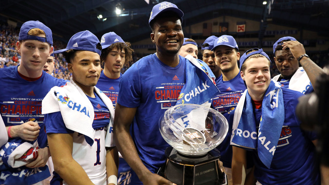 LAWRENCE, KANSAS - MARCH 04: Udoka Azubuike #35 of the Kansas Jayhawks holds the Big 12 Championship Trophy alongside teammates after defeating the TCU Horned Frogs to win the game at Allen Fieldhouse on March 04, 2020 in Lawrence, Kansas.