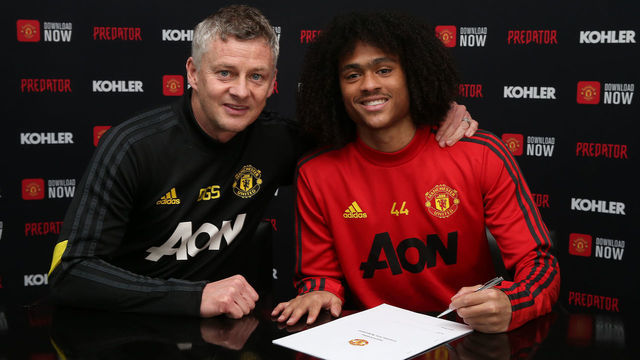 MANCHESTER, ENGLAND - MARCH 09: (EXCLUSIVE COVERAGE) Tahith Chong of Manchester United poses with Manager Ole Gunnar Solskjaer after signing a new contract with Manchester United at Aon Training Complex on March 09, 2020 in Manchester, England.