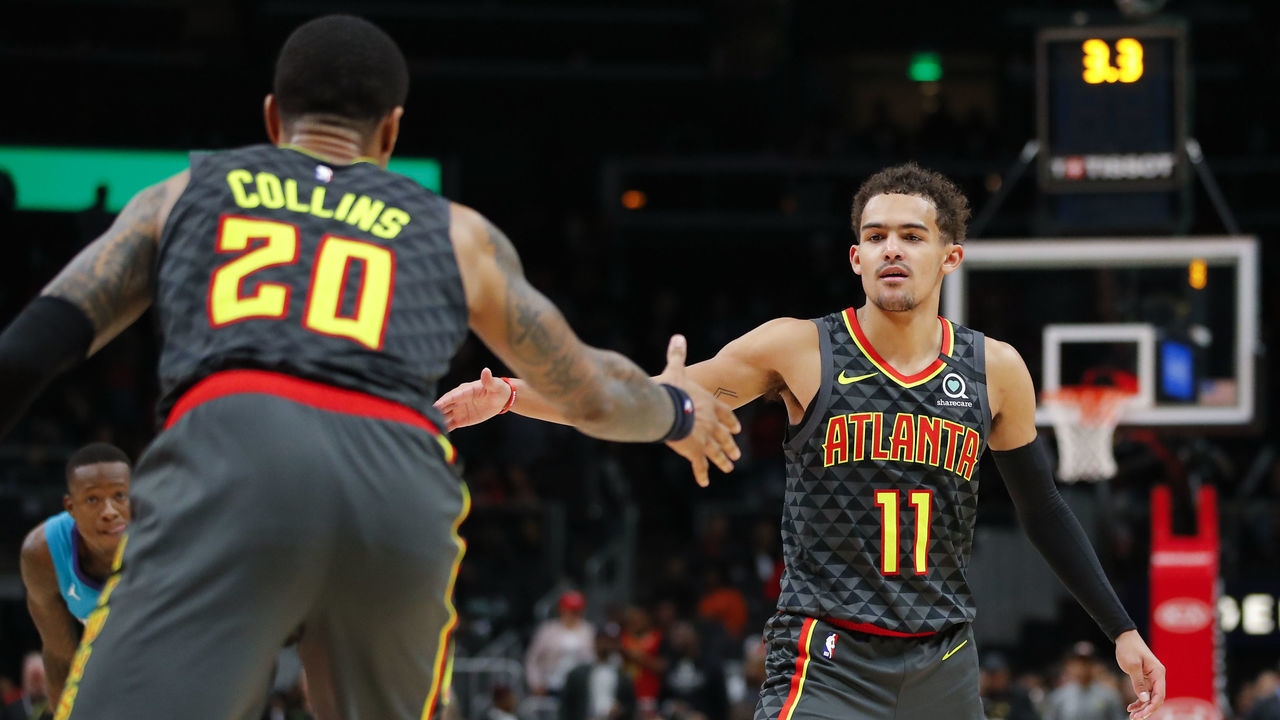 ATLANTA, GA - MARCH 09: Trae Young #11 reacts with John Collins #20 of the Atlanta Hawks during the final seconds of overtime in an NBA game against the Charlotte Hornets at State Farm Arena on March 9, 2020 in Atlanta, Georgia. NOTE TO USER: User expressly acknowledges and agrees that, by downloading and/or using this photograph, user is consenting to the terms and conditions of the Getty Images License Agreement.