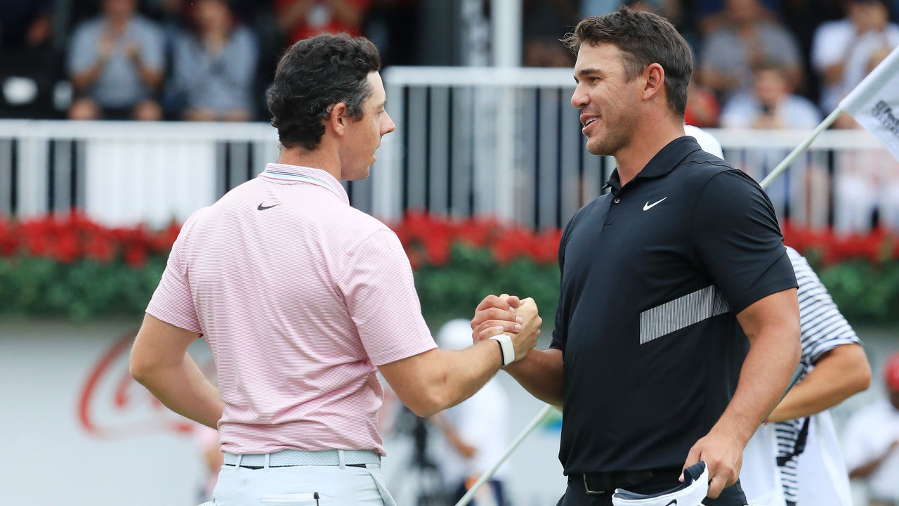 ATLANTA, GEORGIA - AUGUST 25: Brooks Koepka of the United States congratulates Rory McIlroy of Northern Ireland on the 18th green after McIlroy won the FedEx Cup and Tour Championship during the final round of the TOUR Championship at East Lake Golf Club on August 25, 2019 in Atlanta, Georgia.