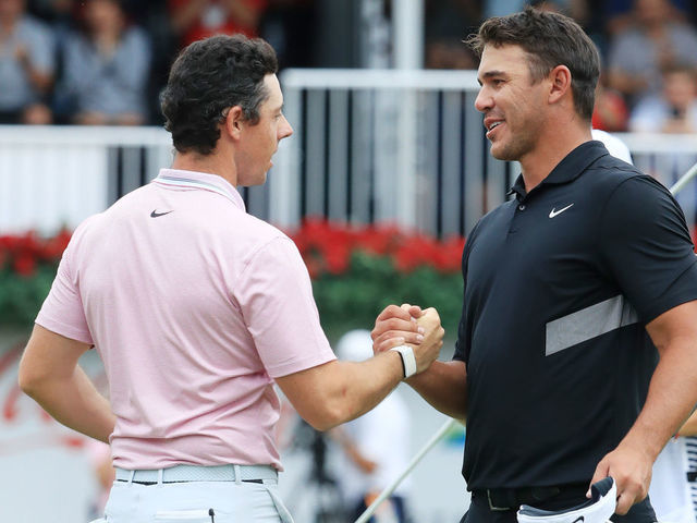 ATLANTA, GEORGIA - AUGUST 25: Brooks Koepka of the United States congratulates Rory McIlroy of Northern Ireland on the 18th green after McIlroy won the FedEx Cup and Tour Championship during the final round of the TOUR Championship at East Lake Golf Club on August 25, 2019 in Atlanta, Georgia.