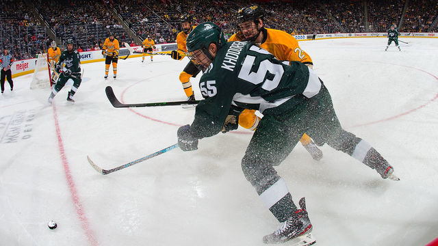 DETROIT, MI - DECEMBER 30: Patrick Khodorenko #55 of the Michigan State Spartans battles in the corner for the puck with Colin Swoyer #24 of the Michigan Tech Huskies in the second period during game one on day one of the 55th Annual Great Lakes Invitational Hockey Tournament at Little Caesars Arena on December 30, 2019 in Detroit, Michigan.