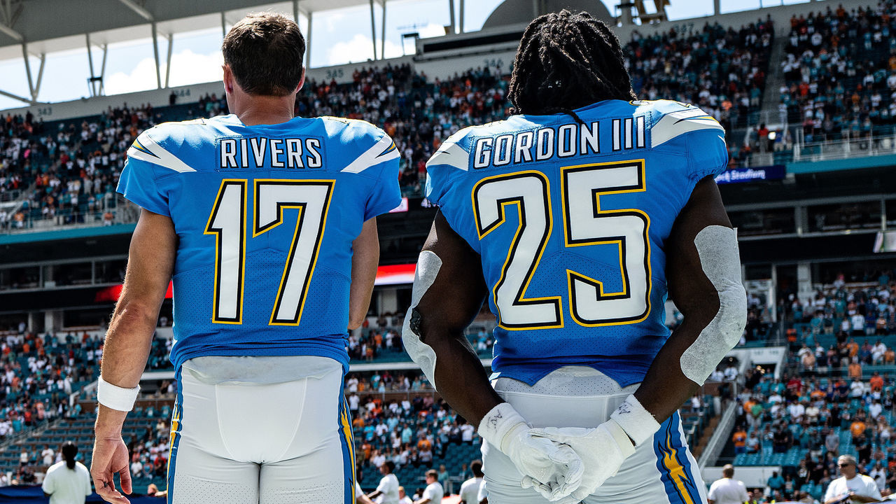 MIAMI, FLORIDA - SEPTEMBER 29: Philip Rivers #17 and Melvin Gordon III #25 of the Los Angeles Chargers stand during the National Anthem prior to the game against the Miami Dolphins at Hard Rock Stadium on September 29, 2019 in Miami, Florida.