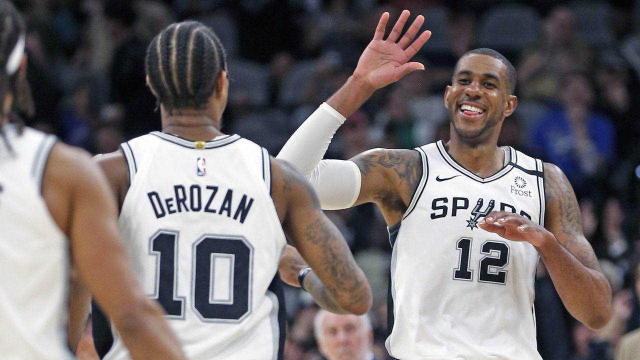SAN ANTONIO, TX - MARCH 10: LaMarcus Aldridge #12 of the San Antonio Spurs celebrates a three with DeMar DeRozan #10 in the fourth quarter at AT&T Center on March 10, 2020 in San Antonio, Texas. San Antonio Spurs defeated the Dallas Mavericks 119-109. NOTE TO USER: User expressly acknowledges and agrees that , by downloading and or using this photograph, User is consenting to the terms and conditions of the Getty Images License Agreement.
