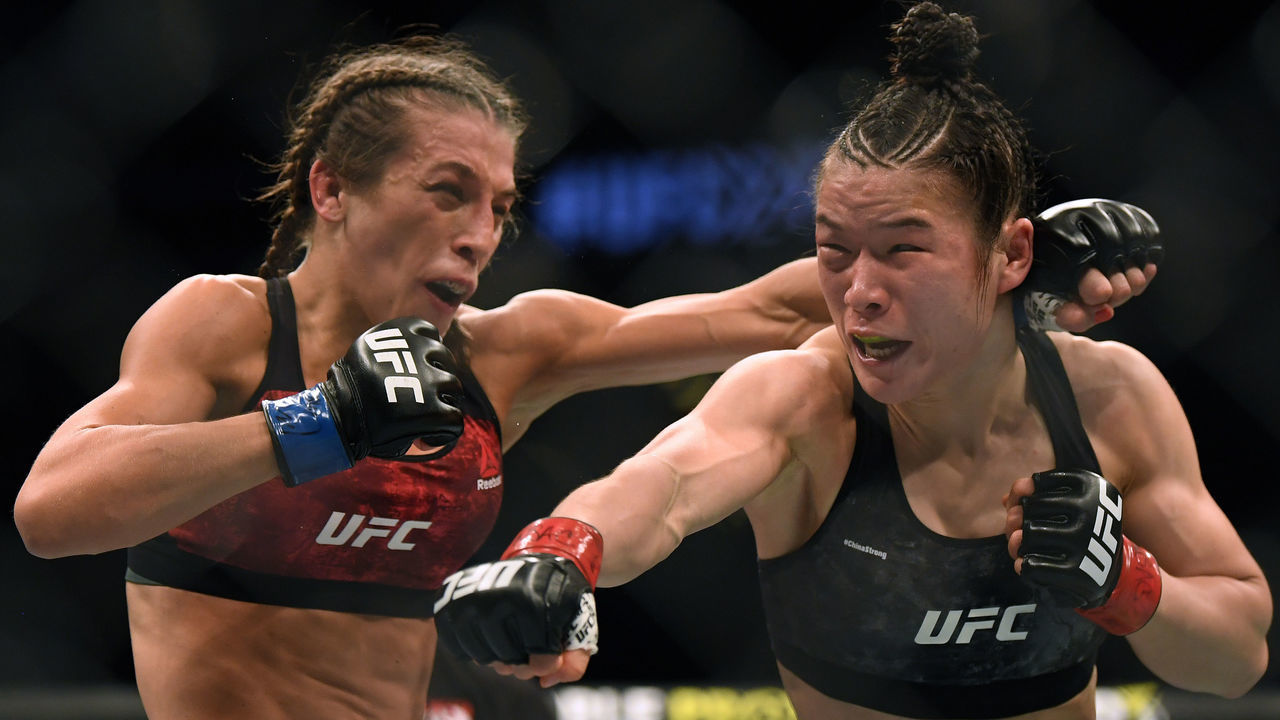 LAS VEGAS, NEVADA - MARCH 07: Weili Zhang punches Joanna Jedrzejczyk during her split decision win to retain her strawweight title at T-Mobile Arena on March 07, 2020 in Las Vegas, Nevada.