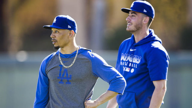 GLENDALE, AZ - FEBRUARY 20: Mookie Betts #50 and Cody Bellinger #35 of the Los Angeles Dodgers look on during a workout after Photo Day on Thursday, February 20, 2020 at Camelback Ranch in Glendale, Arizona.