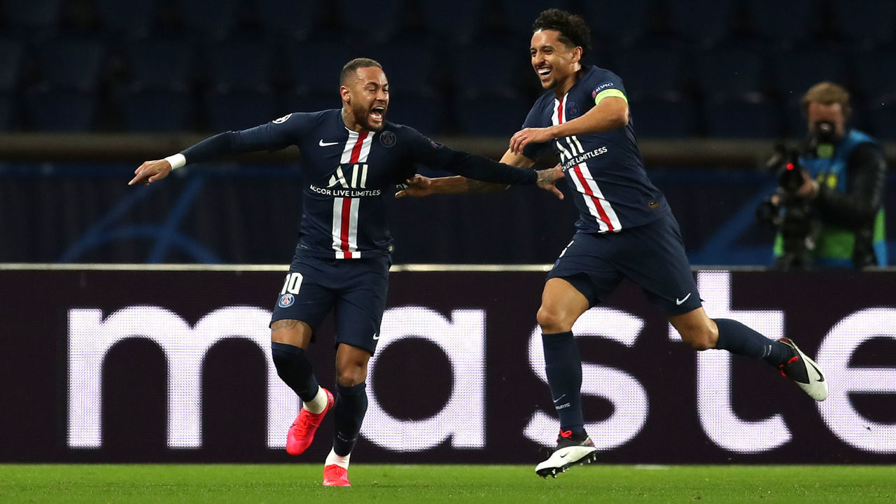 PARIS, FRANCE - MARCH 11: (FREE FOR EDITORIAL USE) In this handout image provided by UEFA, Neymar of Paris Saint-Germain celebrates with Marquinhos after scoring his team's first goal during the UEFA Champions League round of 16 second leg match between Paris Saint-Germain and Borussia Dortmund at Parc des Princes on March 11, 2020 in Paris, France. The match is played behind closed doors as a precaution against the spread of COVID-19 (Coronavirus).
