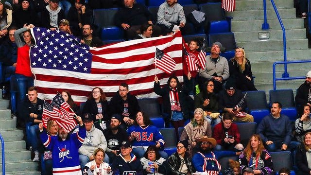 HARTFORD, CT - DECEMBER 14: Fans cheer with American flags during the Canada Women's National Hockey and Team USA Women's Hockey Rivalry Series game on December 14, 2019, at XL Center in Hartford, CT.