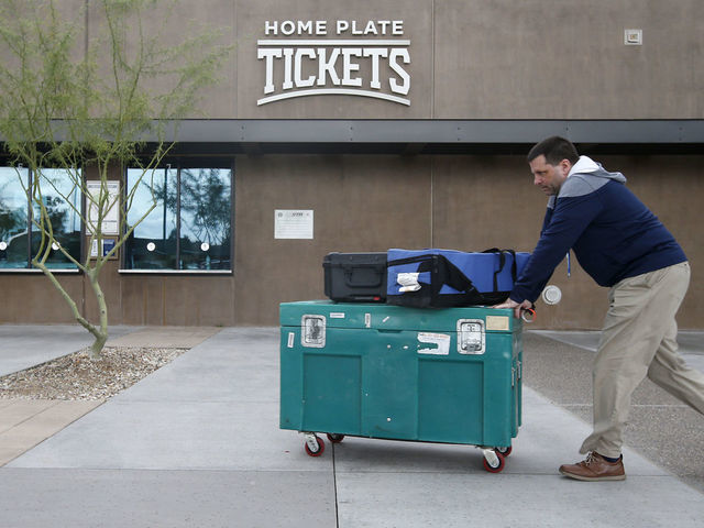 MARYVALE, - MARCH 12: Stadium personnel move equipment past the ticket windows at American Family Fields stadium, spring training home of the Milwaukee Brewers, following Major League Baseball's decision to suspend all spring training games on March 12, 2020 in Phoenix, Arizona. The decision was made due to concerns of the ongoing Coronavirus (COVID-19) outbreak.