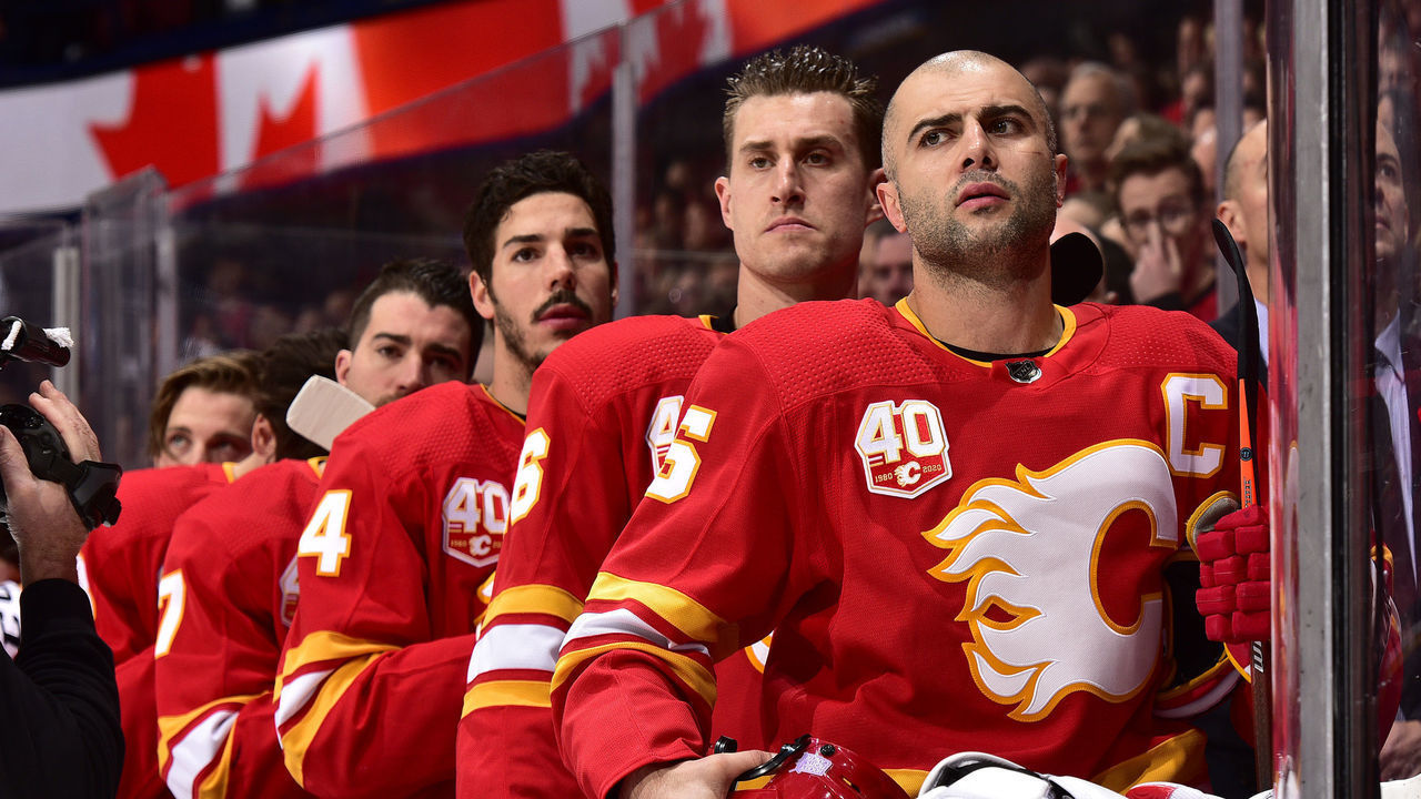 CALGARY, ALBERTA - NOVEMBER 09: Mark Giordano #5 and teammates of the Calgary Flames stand for the national anthems before the game against the St. Louis Blues at Scotiabank Saddledome on November 09, 2019 in Calgary, Canada.