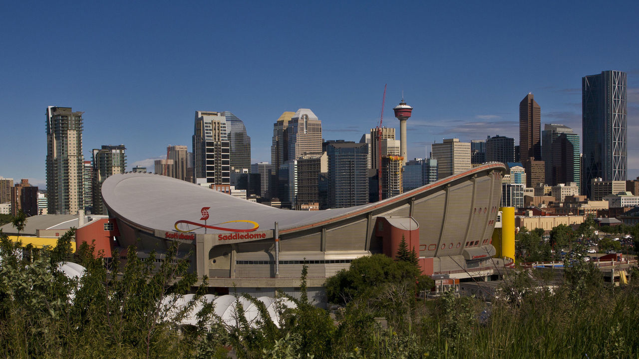 CALGARY, CANADA - JULY 3: The downtown skyline, the Saddledome, and Stampede Park is viewed from a hill to the southeast on July 3, 2012 in Calgary, Canada. Calgary, home to the world famous Stampede, continues to enjoy the benefits of an energy boom that continues across the Alberta province.