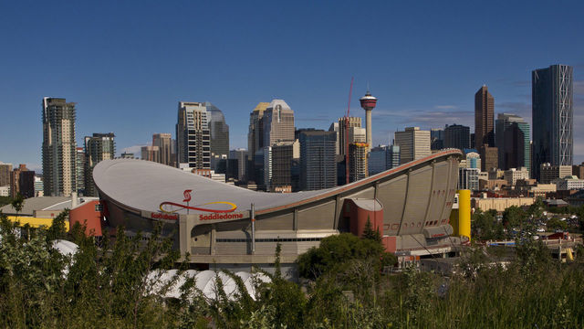 CALGARY, CANADA - JULY 3: The downtown skyline, the Saddledome, and Stampede Park is viewed from a hill to the southeast on July 3, 2012 in Calgary, Canada. Calgary, home to the world famous Stampede, continues to enjoy the benefits of an energy boom that continues across the Alberta province.