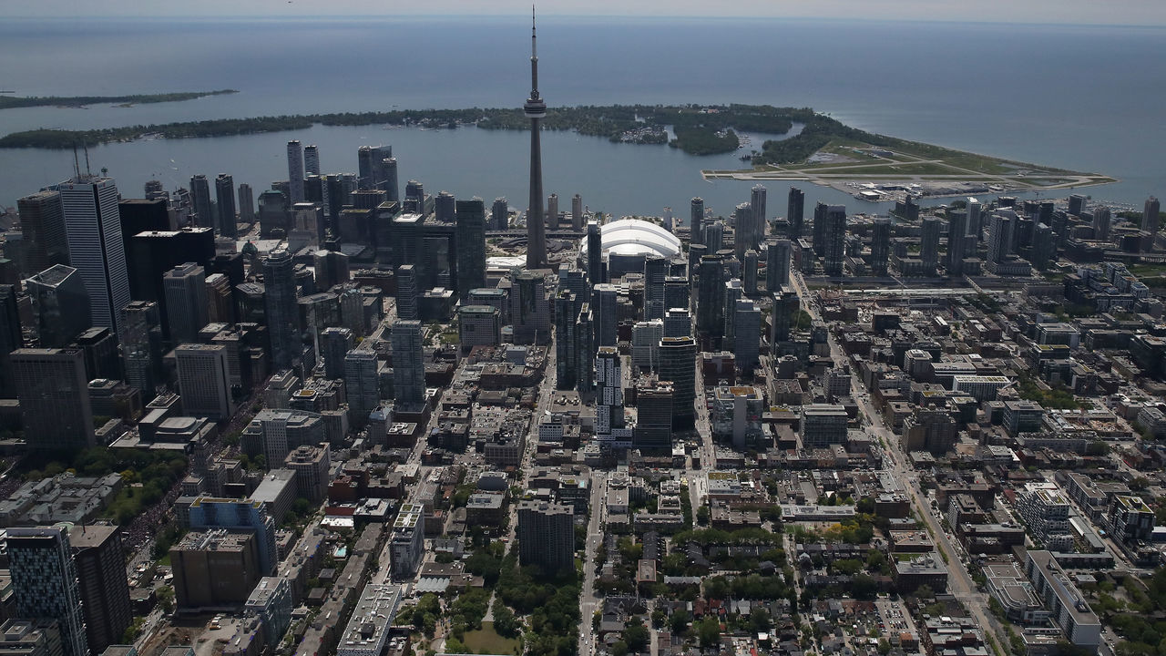 TORONTO, ON - JUNE 17: An aerial view of the Rogers Centre and CN Tower and city skyline and islands on Lake Ontario on June 17, 2019 in Toronto, Canada.