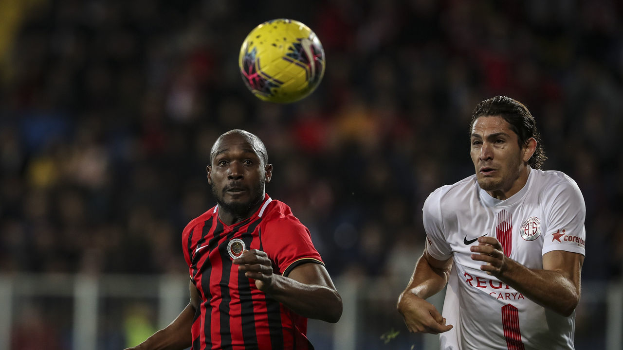 ANKARA, TURKEY - MARCH 9: Gustavo (R) of Fraport TAV Antalyaspor in action against Giovanni Sio of Genclerbirligi during Turkish Super Lig soccer match between Genclerbirligi and Fraport TAV Antalyaspor at Eryaman Stadium in Ankara, Turkey on March 9, 2020.