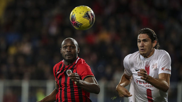 ANKARA, TURKEY - MARCH 9: Gustavo (R) of Fraport TAV Antalyaspor in action against Giovanni Sio of Genclerbirligi during Turkish Super Lig soccer match between Genclerbirligi and Fraport TAV Antalyaspor at Eryaman Stadium in Ankara, Turkey on March 9, 2020.