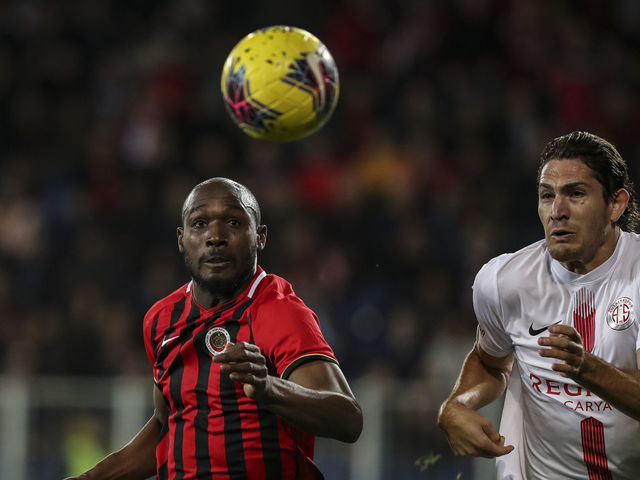 ANKARA, TURKEY - MARCH 9: Gustavo (R) of Fraport TAV Antalyaspor in action against Giovanni Sio of Genclerbirligi during Turkish Super Lig soccer match between Genclerbirligi and Fraport TAV Antalyaspor at Eryaman Stadium in Ankara, Turkey on March 9, 2020.