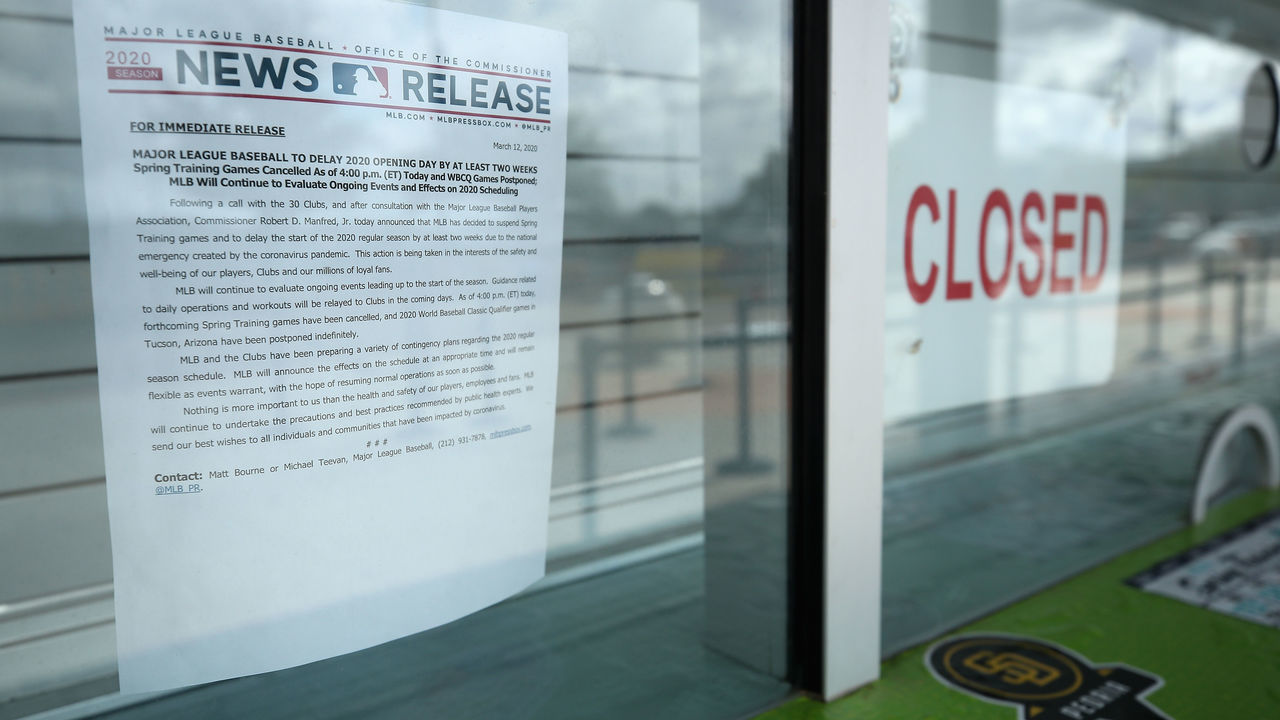 PEORIA, ARIZONA - MARCH 13: Closed signs and MLB news releases are displayed on box office windows outside of Peoria Stadium, home of the San Diego Padres and Seattle Mariners on March 13, 2020 in Peoria, Arizona. Major League Baseball cancelled spring training games and has delayed opening day by at least two weeks due to COVID-19.