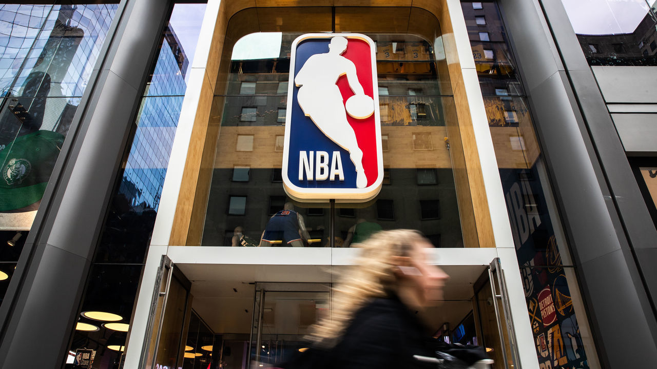 NEW YORK, NY - MARCH 12: A pedestrian walks past the NBA store on 5th Avenue on March 12, 2020 in New York City. The National Basketball Association said they would suspend all games after player Rudy Gobert of the Utah Jazz reportedly tested positive for the Coronavirus (COVID-19).