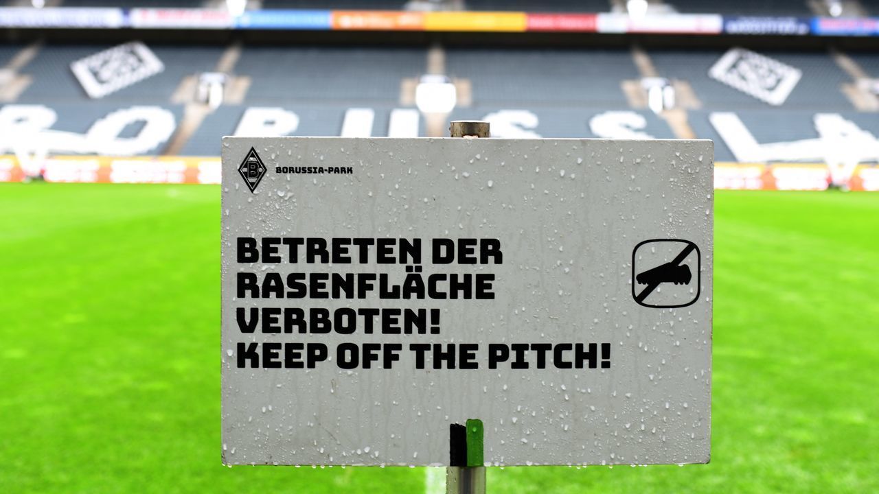 A sign reading "keep of the pitch" at the corner of the pitch is pictured at Borussia-Park football stadium on March 10, 2020 in Mönchengladbach. - Rhine Bundesliga derby between Borussia Moenchengladbach and Cologne, scheduled for March 11, 2020, will be held behind closed doors due to the coronavirus, the first game in Bundesliga history to be played without fans, club officials announced on March 10, 2020. Bundesliga games had been going ahead as usual, even as the number of people testing positive for the coronavirus continued to rise in Germany, passing 1,000 on March 10, 2020.