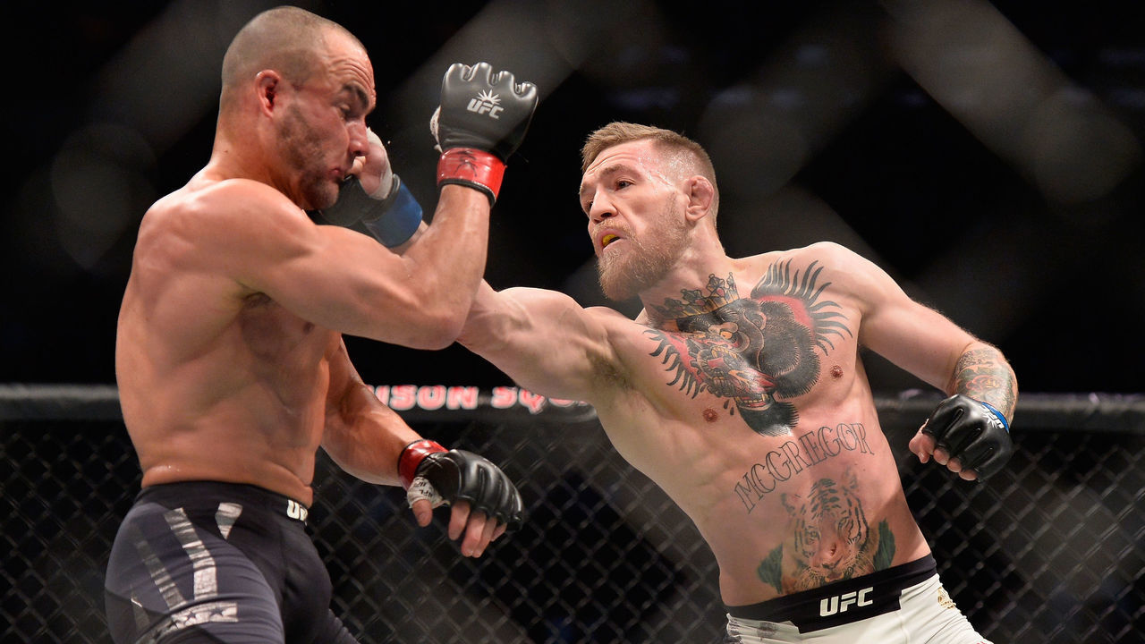 NEW YORK, NY - NOVEMBER 12: (R-L) Conor McGregor of Ireland punches Eddie Alvarez in their UFC lightweight championship fight in their UFC lightweight championship fight during the UFC 205 event at Madison Square Garden on November 12, 2016 in New York City.