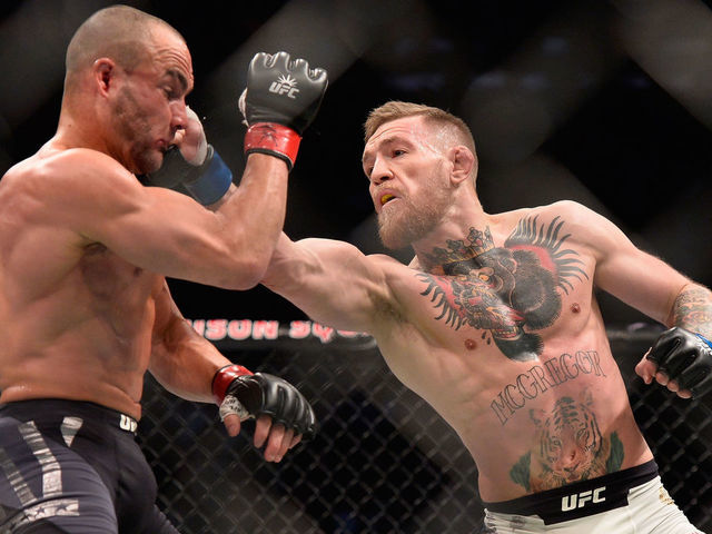 NEW YORK, NY - NOVEMBER 12: (R-L) Conor McGregor of Ireland punches Eddie Alvarez in their UFC lightweight championship fight in their UFC lightweight championship fight during the UFC 205 event at Madison Square Garden on November 12, 2016 in New York City.