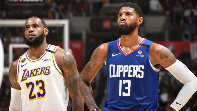 LOS ANGELES, CA - MARCH 8: LeBron James #23 of the Los Angeles Lakers and Paul George #13 of the LA Clippers look on during the game on March 8, 2020 at STAPLES Center in Los Angeles, California. NOTE TO USER: User expressly acknowledges and agrees that, by downloading and/or using this Photograph, user is consenting to the terms and conditions of the Getty Images License Agreement. Mandatory Copyright Notice: Copyright 2020 NBAE