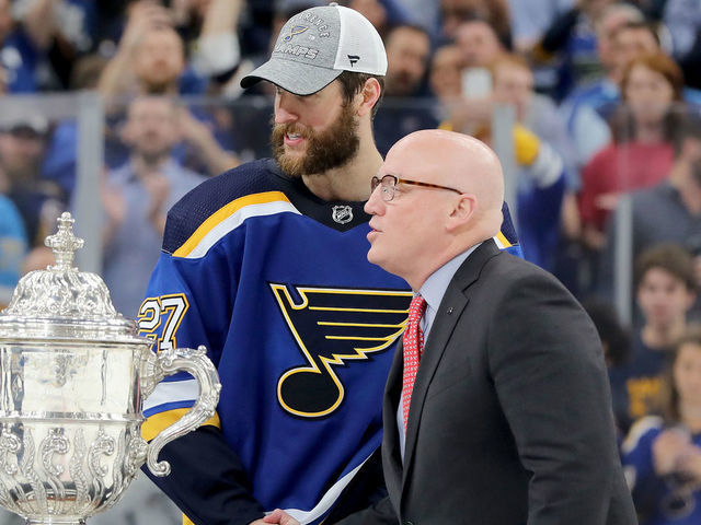 ST LOUIS, MISSOURI - MAY 21: NHL Deputy Commissioner Bill Daly shakes hands with Alex Pietrangelo #27 prior to presenting the Clarence S. Campbell Bowl to the St. Louis Blues after defeating the San Jose Sharks in Game Six with a score of 5 to 1 to win the Western Conference Finals during the 2019 NHL Stanley Cup Playoffs at Enterprise Center on May 21, 2019 in St Louis, Missouri.