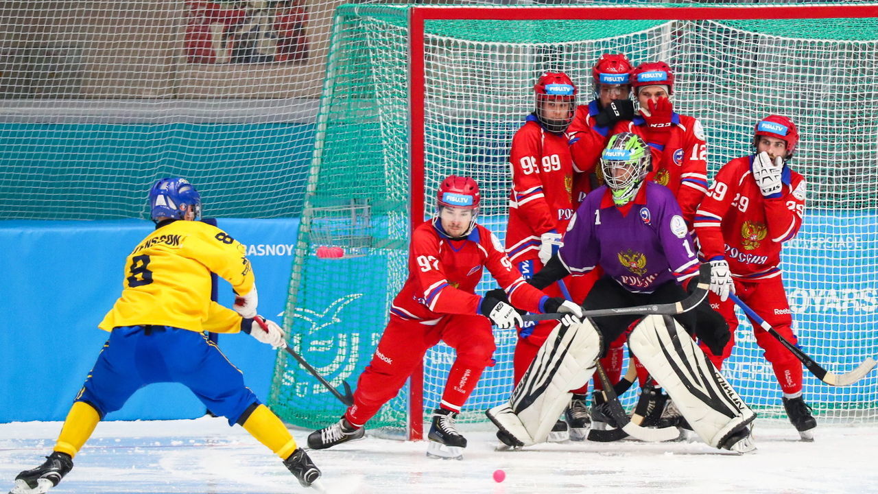 KRASNOYARSK, RUSSIA - MARCH 10, 2019: Sweden's Max Maartensson (L), Russia's players (R) in the men's bandy gold medal match between Russia and Sweden at the 2019 Winter Universiade. Peter Kovalev/TASS