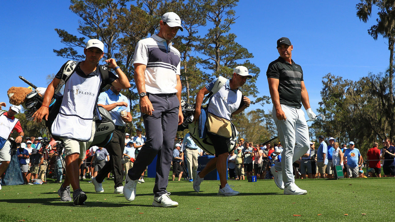 PONTE VEDRA BEACH, FLORIDA - MARCH 12: Rory McIlroy of Northern Ireland walks off the sixth tee with Brooks Koepka of the United States during the first round of The PLAYERS Championship on The Stadium Course at TPC Sawgrass on March 12, 2020 in Ponte Vedra Beach, Florida.