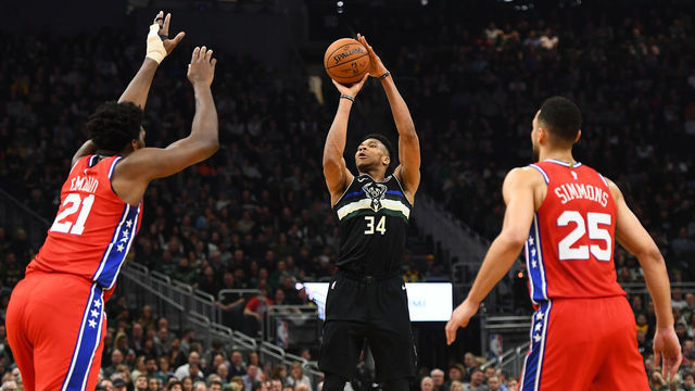 MILWAUKEE, WISCONSIN - FEBRUARY 06: Giannis Antetokounmpo #34 of the Milwaukee Bucks shoots over Joel Embiid #21 of the Philadelphia 76ers during a game at Fiserv Forum on February 06, 2020 in Milwaukee, Wisconsin.
