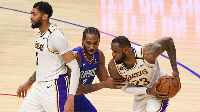 LOS ANGELES, CA - MARCH 08: Los Angeles Lakers Forward Anthony Davis (3) and Los Angeles Clippers Forward Kawhi Leonard (2) defends Los Angeles Lakers Forward LeBron James (23) during a NBA game between the Los Angeles Lakers and the Los Angeles Clippers on March 8, 2020 at STAPLES Center in Los Angeles, CA.