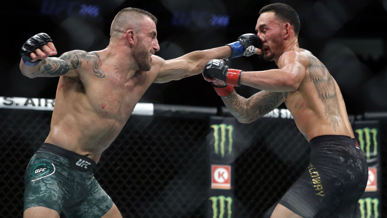 LAS VEGAS, NEVADA - DECEMBER 14: Alexander Volkanovski (L) punches UFC featherweight champion Max Holloway in their title fight during UFC 245 at T-Mobile Arena on December 14, 2019 in Las Vegas, Nevada. Volkanovski took the title by unanimous decision.