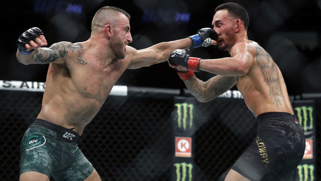 LAS VEGAS, NEVADA - DECEMBER 14: Alexander Volkanovski (L) punches UFC featherweight champion Max Holloway in their title fight during UFC 245 at T-Mobile Arena on December 14, 2019 in Las Vegas, Nevada. Volkanovski took the title by unanimous decision.