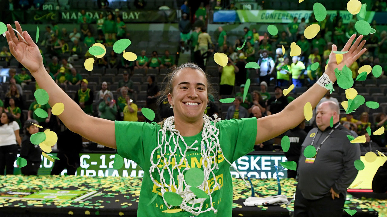 LAS VEGAS, NEVADA - MARCH 08: Sabrina Ionescu #20 of the Oregon Ducks wears a basketball net around her neck and throws confetti in the air as she celebrates her team's 89-56 win over the Stanford Cardinal to win the championship game of the Pac-12 Conference women's basketball tournament at the Mandalay Bay Events Center on March 8, 2020 in Las Vegas, Nevada.