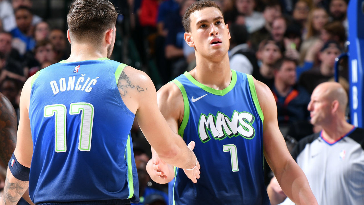 DALLAS, TX - DECEMBER 26: Luka Doncic #77 high-fives Dorian Finney-Smith #10 and Dwight Powell #7 of the Dallas Mavericks against the San Antonio Spurs on December 26, 2019 at the American Airlines Center in Dallas, Texas. Mandatory Copyright Notice: Copyright 2019 NBAE