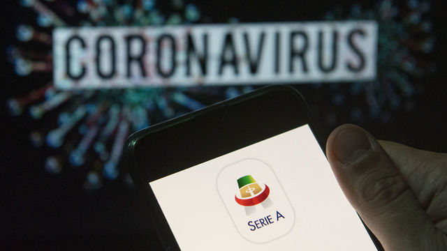 CHINA - 2020/03/24: In this photo illustration the Italian football professional top division Serie A logo seen displayed on a smartphone with a computer model of the COVID-19 coronavirus on the background. (Photo Illustration by Budrul Chukrut/SOPA Images/LightRocket via Getty Images)
