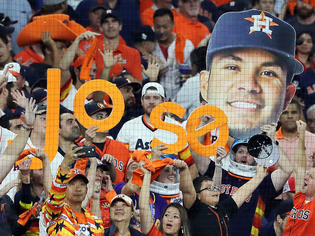 HOUSTON, TEXAS - OCTOBER 29: Fans hold signs referencing Jose Altuve (not pictured) of the Houston Astros during the eighth inning in Game Six of the 2019 World Series between the Houston Astros and the Washington Nationals at Minute Maid Park on October 29, 2019 in Houston, Texas.