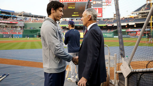 WASHINGTON, DC - OCTOBER 01: Christian Yelich #22 of the Milwaukee Brewers talks with Major League Baseball Commissioner Robert D. Manfred Jr. during batting practice prior to the NL Wild Card game between the Milwaukee Brewers and the Washington Nationals at Nationals Park on Tuesday, October 1, 2019 in Washington, District of Columbia.