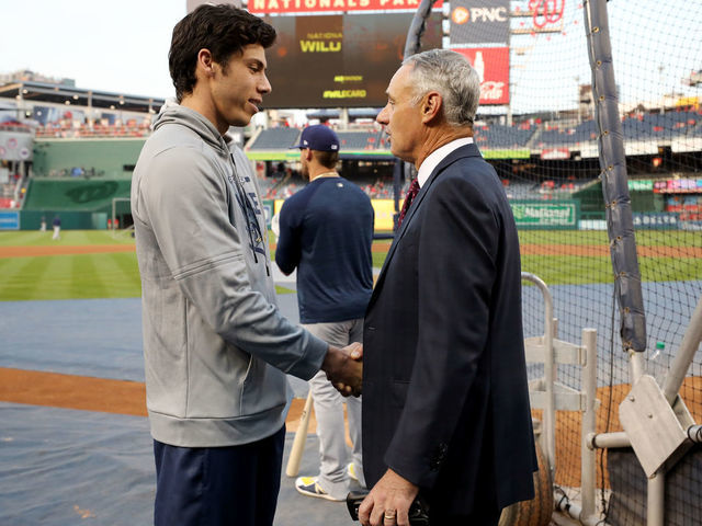 WASHINGTON, DC - OCTOBER 01: Christian Yelich #22 of the Milwaukee Brewers talks with Major League Baseball Commissioner Robert D. Manfred Jr. during batting practice prior to the NL Wild Card game between the Milwaukee Brewers and the Washington Nationals at Nationals Park on Tuesday, October 1, 2019 in Washington, District of Columbia.