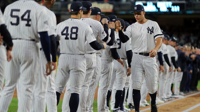 BRONX, NY - OCTOBER 04: Aaron Judge #99 of the New York Yankees hi-fives his teammates during player introductions prior to the ALDS Game 1 between the Minnesota Twins and the New York Yankees at Yankee Stadium on Friday, October 4, 2019 in the Bronx borough of New York City.