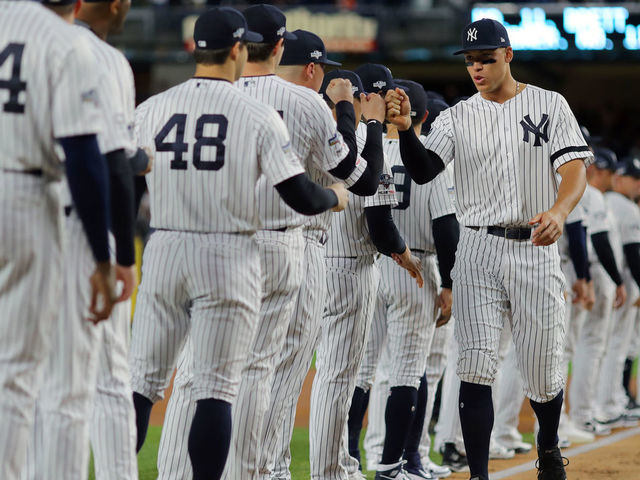 BRONX, NY - OCTOBER 04: Aaron Judge #99 of the New York Yankees hi-fives his teammates during player introductions prior to the ALDS Game 1 between the Minnesota Twins and the New York Yankees at Yankee Stadium on Friday, October 4, 2019 in the Bronx borough of New York City.
