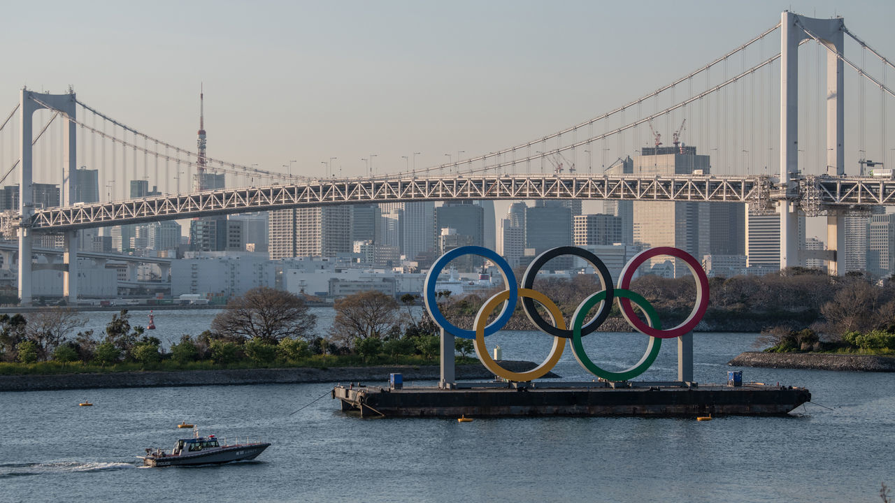 TOKYO, JAPAN - MARCH 25: A police boat passes the Tokyo 2020 Olympic Rings on March 25, 2020 in Tokyo, Japan. Following yesterdays announcement that the Tokyo 2020 Olympics will be postponed to 2021 because of the ongoing Covid-19 coronavirus pandemic, IOC officials have said they hope to confirm a new Olympics date as soon as possible.