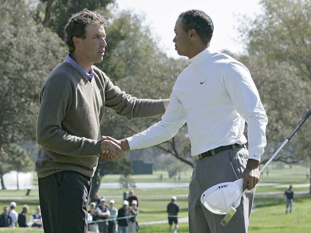 Stephen Ames congratulates Tiger Woods after Woods won their match during the first round of the 2006 Accenture Match Play Championship at the La Costa Resort & Spa in Carlsbad, California on February 22, 2006.