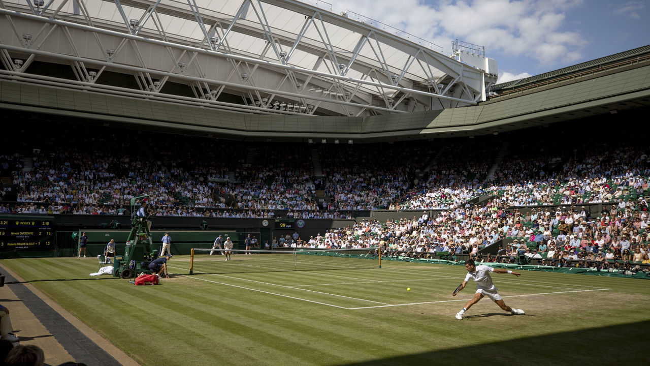 LONDON, ENGLAND - July 12: A general view of Novak Djokovic of Serbia in action against Roberto Bautista Agut of Spain during the Men's Singles Semifinals on Centre Court during the Wimbledon Lawn Tennis Championships at the All England Lawn Tennis and Croquet Club at Wimbledon on July 12, 2019 in London, England.