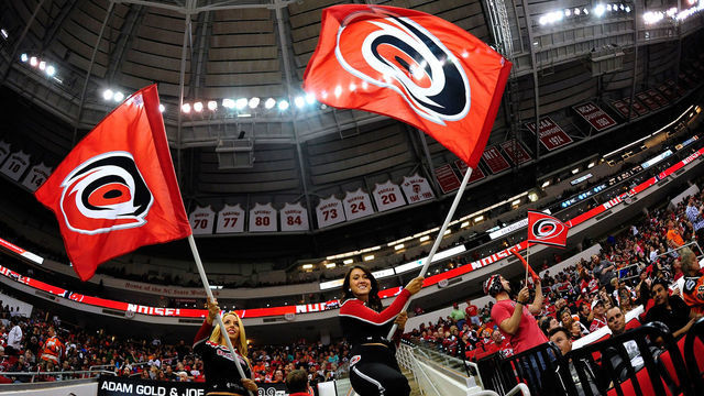 RALEIGH, NC - OCTOBER 06: Members of the Carolina Hurricanes Storm Squad cheer during a win over the Philadelphia Flyers at PNC Arena on October 6, 2013 in Raleigh, North Carolina. The Hurricnes won 2-1.