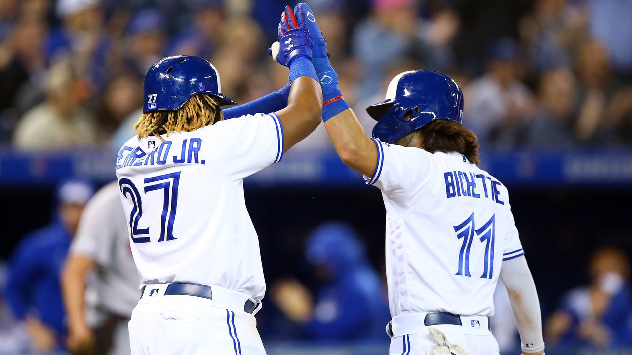 TORONTO, ON - SEPTEMBER 12: Bo Bichette #11 of the Toronto Blue Jays is congratulated by Vladimir Guerrero Jr. #27 after scoring on a triple by Cavan Biggio #8 in the fifth inning during a MLB game against the Boston Red Sox at Rogers Centre on September 12, 2019 in Toronto, Canada.