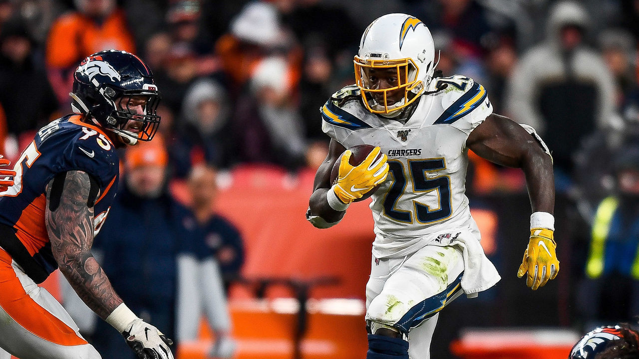 DENVER, CO - DECEMBER 1: Melvin Gordon #25 of the Los Angeles Chargers rushes against the Denver Broncos in the fourth quarter of a game at Empower Field at Mile High on December 1, 2019 in Denver, Colorado.