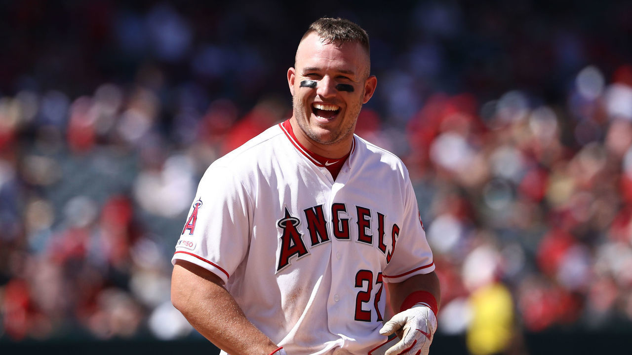 ANAHEIM, CALIFORNIA - APRIL 07: Mike Trout #27 of the Los Angeles Angels of Anaheim has a laugh with Elvis Andrus #1 of the Texas Rangers (not in photo) after the fourth inning of the MLB game at Angel Stadium of Anaheim on April 07, 2019 in Anaheim, California. The Angels defeated the Rangers 7-2.